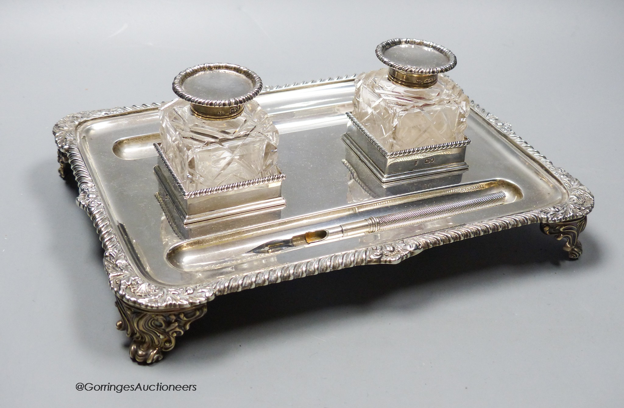A late Victorian silver rectangular inkstand, with two mounted glass wells, Thomas Bradbury & Sons, London, 1896, 23.6cm, 16oz